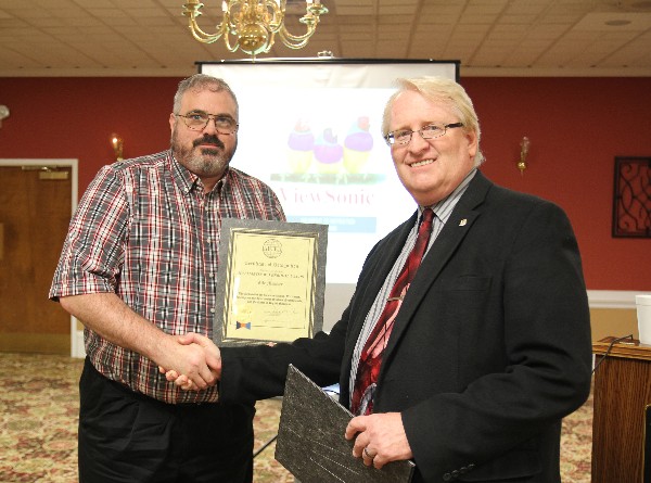 Martin Verboom (l), TRADOC capability manager for networks and services, receives his Life Member certificate from Coffey at the chapter's February luncheon.