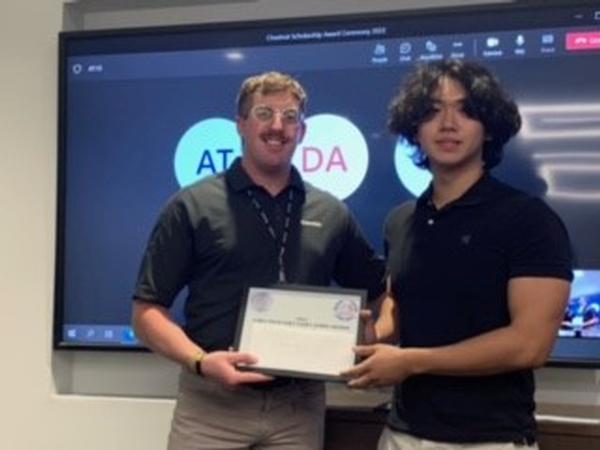 Matthew She receives a STEM scholarship at the June event.