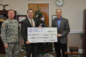 In December, Bob Damen (c), chapter president, presents a check for $1,586 to James Greene (r), director, Fort Gordon Morale Welfare and Recreation Activity, along with Col. Ron Stephens, USA, chief of staff, U.S. Army Signal Center.