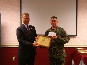 Staff Sgt. James Kundert, USAF, receives the $1,500 Jerry Lapp Memorial Scholarship from Joe Yavorsky, chapter president, in August. 