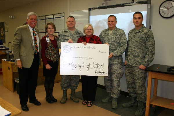 Members of the chapter present Mosely High School teacher Florence Lindsay with a STEM grant for the school's environmental engineering program. 