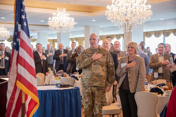 Col. Chad Harris, USA, project manager Defensive Cyber Operations (DCO), and Pat Ocasio, deputy project manager, DCO, leads the Pledge of Allegiance at the January luncheon