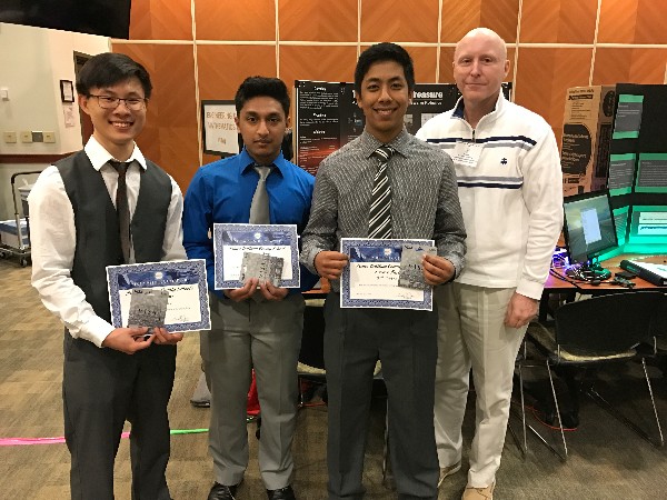 Chapter President Bill Jones (far r) meets with a group of awardees and on-the-spot cash award recipients at he Prince William County Science and Engineering Fair in March.