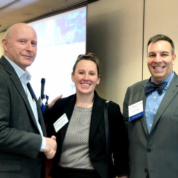 Chapter President Bill Jones (l) and Vice President of Small Business Eric Strauss welcome Stephanie Shutt, director, General Service Administration's Multiple Award Schedule Program Management Office, at the March meeting. 