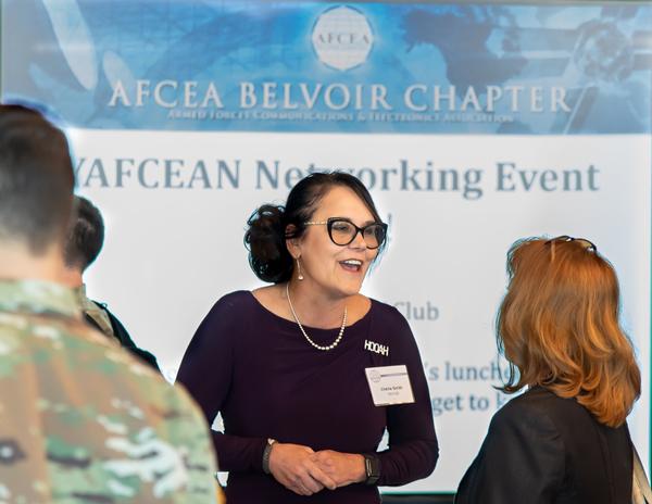 Chérie Smith, program executive officer for enterprise information systems, engages with industry following her presentation at the chapter's September kickoff luncheon.