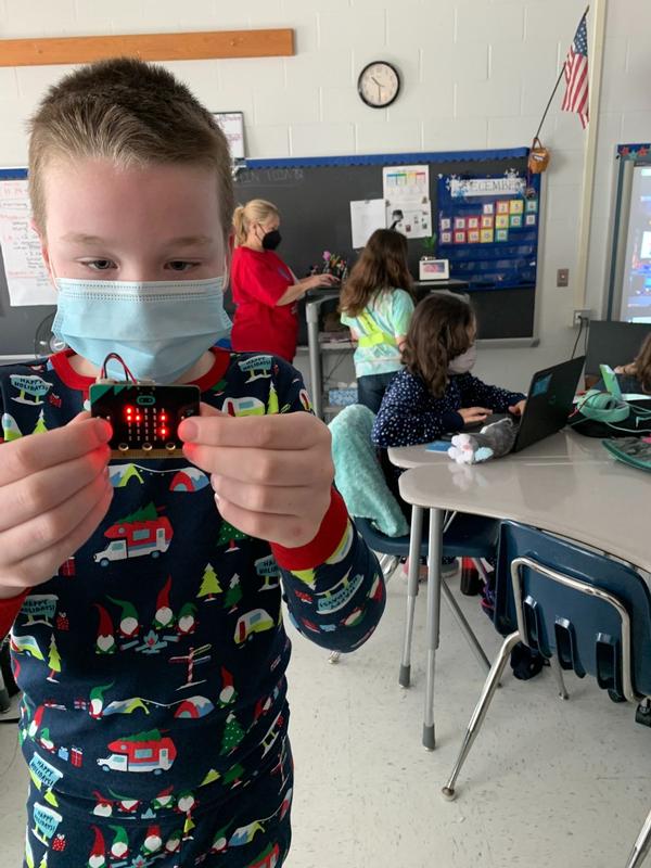 Dylan Besaw, 10, inspects a microbot he built, as part of an Escape the Planet Coding Challenge. Besaw and all other fifth-graders at Fort Belvoir Upper School participated in the two-day event before the holidays, on the school's pajama day, in partnership with volunteers from the chapter.