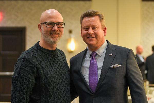 Chapter President Jim Evans (r) and guest speaker Aric Sherwood pause for a photo at the February luncheon.