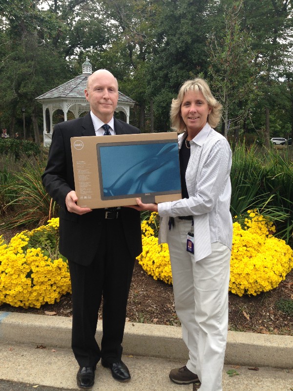 In October, Bill Jones, chapter president, presents Kim Gadson of Mark Twain Middle School with five monitors for inclusion in their STEM lab.