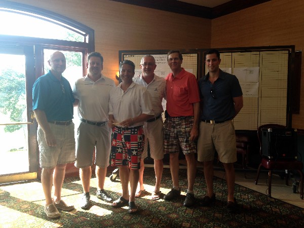 The first place team celebrates its win after the AFCEA Belvoir Education Golf Tournament in June.