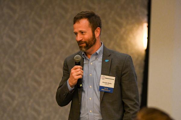 Brendan Burke, chapter executive vice president and former deputy program executive officer for Program Executive Office Enterprise Information Systems, addresses the attendees at the February event. 