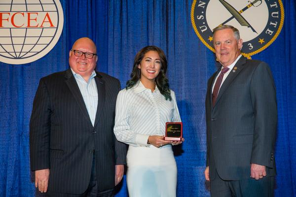AFCEA Chairman of the Board Joe Sifer (l) and Lt. Gen. Robert M. Shea, USMC (Ret.), AFCEA president and CEO, congratulate Theresa Holland, Young AFCEA Bethesda board member, on receiving AFCEA International's Distinguished Young AFCEAN Award in February at San Diego's West conference. The conference is co-sponsored by AFCEA and the U.S. Naval Institute.