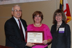 In April, Kenneth Touloumes (l), chapter president; Helene Johnson (c), chapter vice president for education; and Norma Corrales, director, scholarships and awards program, AFCEA International, help present $100,000 in scholarships to Maryland college students.