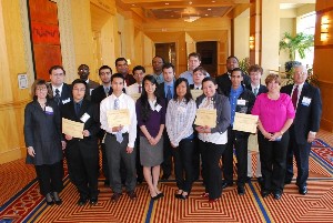Students receive their scholarships from chapter members in April. The students, who all are majoring in information technology or engineering, received awards totaling more than $100,000. 