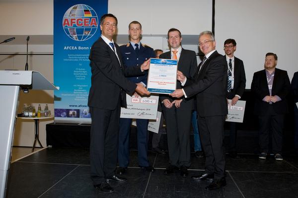 Michael Wunder (l), chapter vice president of academia, presents the AFCEA Study Award to Lt. Marcel Antzek (second from l), along with (l-r) his professor Volker Eiseler, the University of the Armed Forces in Munich, and Maj. Gen. Erich Staudacher, GEAF (Ret.), AFCEA Europe General Manager, at the IT Symposium in September. 