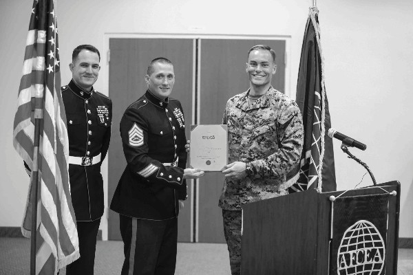 Capt. Thomas Cunningham, USMC (r), accepts a Commander's Award from Commanding General Marine Forces Reserve recognizing the chapter for support of the 2013 Marine Toys for Tots Program. Presenting the award are Gunnery Sgt. Matthew Klepsa, USMC (c), and Staff Sgt. John Farrell, USMC, from the 4th Light Armored Reconnaissance Battalion.