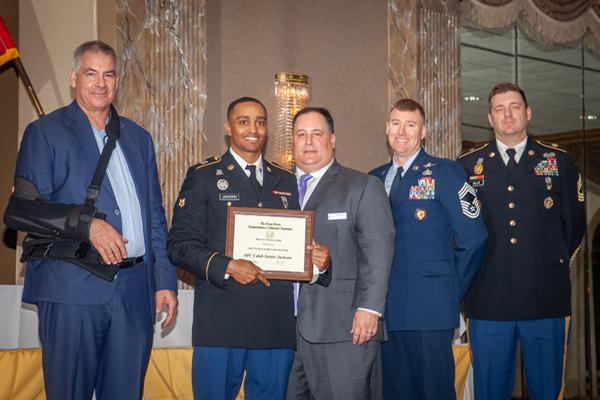 Chapter leaders present the military scholarship at the annual awards night in May.