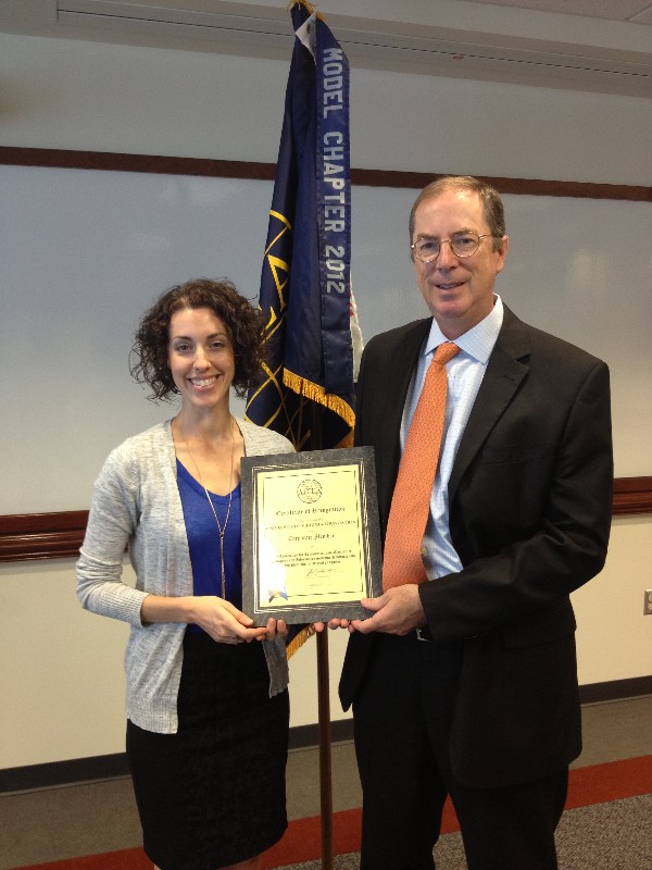 Tim Rose and Katie Murphy accept a certificate of corporate membership for the University of Virginia Foundation at the September luncheon.