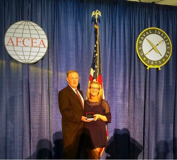 Jenifer Peguero, chapter vice president of communications, receives the Distinguished Young AFCEAN Award from Lt. Gen. Robert M. Shea, USMC (Ret.), president and CEO of AFCEA International, at West in February. 