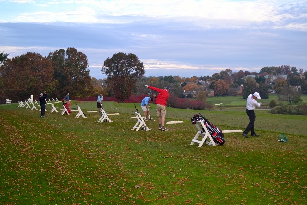 At the October 2014 golf tournament, participants hit balls before the event.