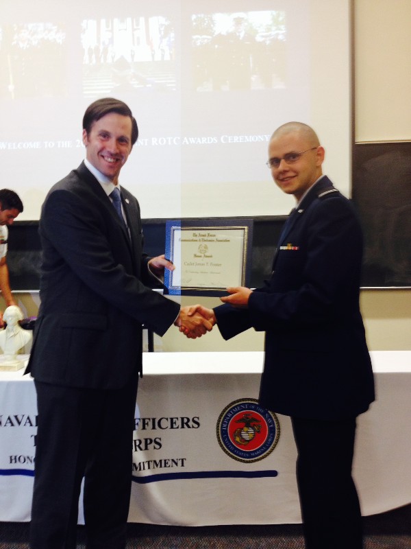 Reagan (l) presents Cadet Jonas Foster, Air Force ROTC, with an ROTC Award in April.