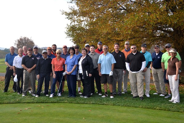 Participants in the October 2014 golf tournament supporting science, technology, engineering and mathematics stop for a group shot. 