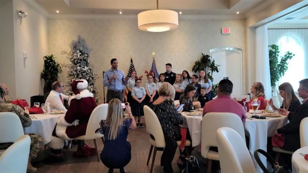 One of the Hope Children's Home directors addresses the chapter at the December event.