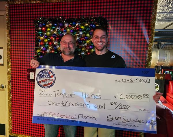 In February, Ceglar (l) presents a STEM Scholarship to Taylor Hanes, cyber intelligence major, University of South Florida. 