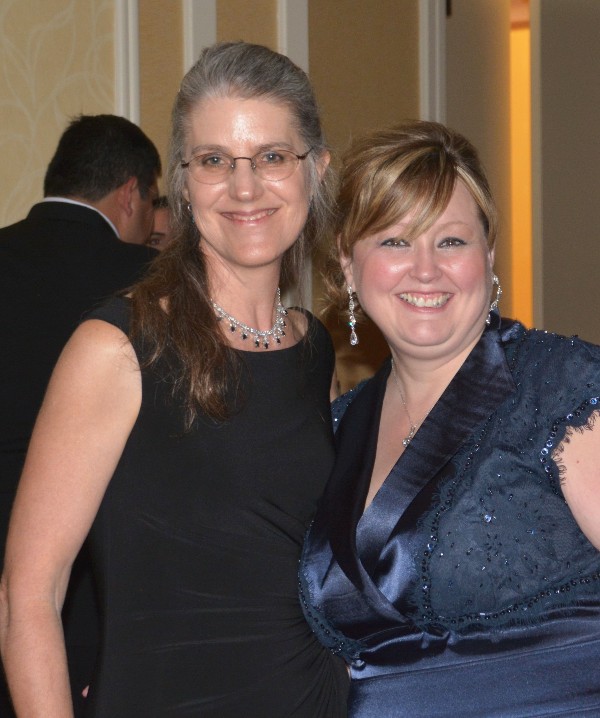 Dr. Deb Frincke (l), guest speaker, and Jennifer Stacey, CACI, network during the chapter's Valentine's Gala in February.