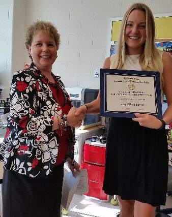 The chapter's vice president, scientific education, Jessica Morgenstern (l), presents a $5,000 scholarship award in October to Amy Talvac, a teacher at Carderock Springs Elementary School in Bethesda, Maryland.