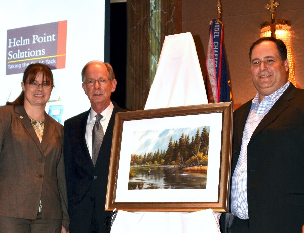 Chapter President Jen Havermann (l) and Vice President Brian Cooper (r) present a framed fly fishing print to Steve Richey upon his retirement from the position of vice president, Intelligence Committee for AFCEA International at the luncheon in September. 