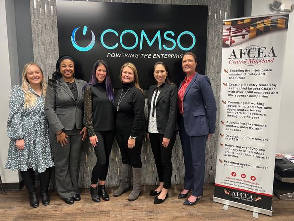 Panelists Stacy Trammell, president and CEO at Zavda Technologies LLC (c); Jacqui Magnes, CEO at COMSO (second from l); and Alison Flanigan, CEO at Omega Minds (third from l); with moderator Tiffany Tong, chapter vice president of WIA and business development/capture manager at Leidos (second from r), gather for a photo with Amy Ratzburg, chapter vice president of WIA (far l); and Kirsten Miller-Jones, chapter vice president of small business affairs (far r), at the January event.