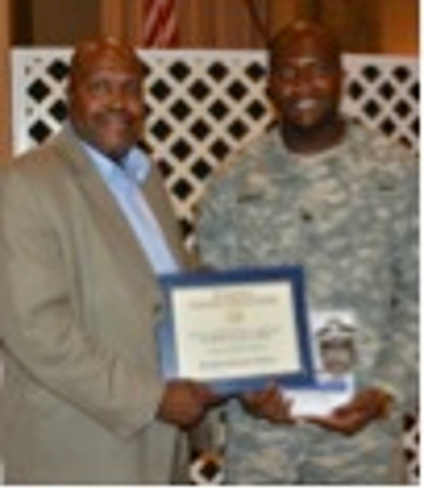 Chinedu Ilobinso (r), a junior at Morgan State University majoring in electrical engineering, receives a scholarship award from Ariel Wilkins of Avaya Corporation in September.