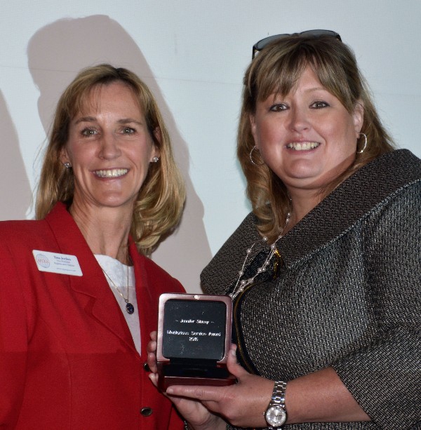 Tina Jordan (l), vice president, Region and Chapter Outreach, AFCEA, presents the the Meritorious Service Award to Jennifer Stacey, chapter vice president of events in September. 