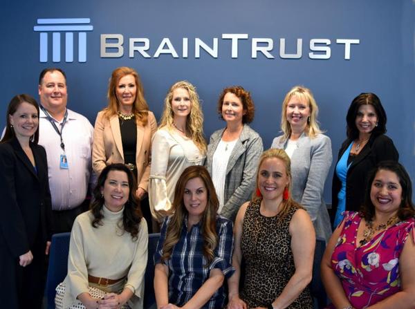 The WIIG In A Minute Planning Team and WIIG In A Minute Mentors pose for a photo with representatives from host BrainTrust at the April event.