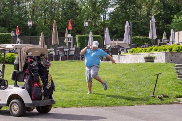 Brian Cooper, chapter chair of the board of directors, strikes a pose while out on the links at the May event.