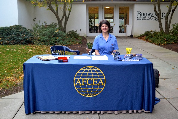 A volunteer supports the sign-in table at the golf event in October 2014.