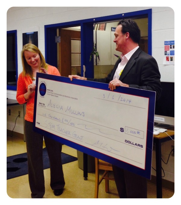 In March, Adrian Felts, chapter president, presents a STEM Teaching Tools grant to Alecia Mullins from Madison County High School.