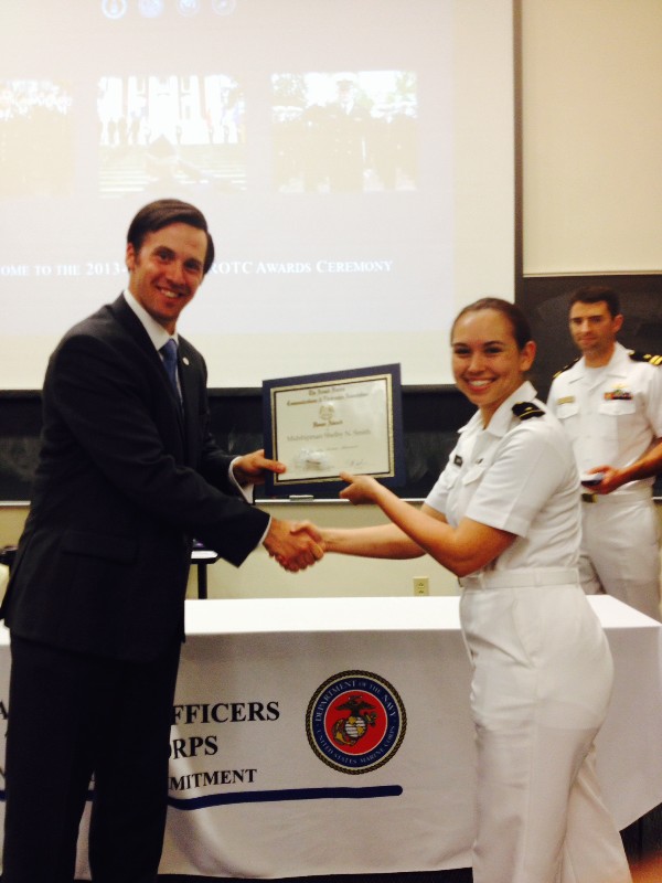 In April, Midshipman Shelby Smith, Navy ROTC, accepts an ROTC Award from Reagan.