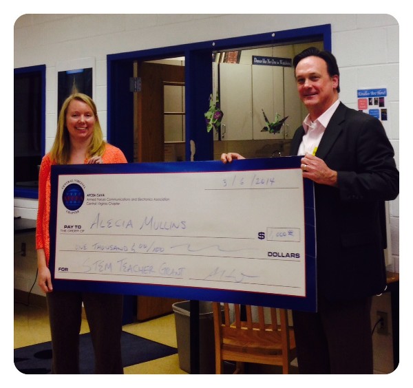 Alecia Mullins from Madison County High School receives a STEM Teaching Tools grant from Adrian Felts, chapter president, in March. The grant will go toward Trout in the Classroom, a program providing hands-on learning with scientific equipment.