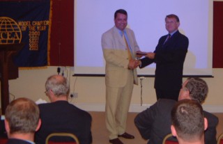 Chapter President Tom Moncur (r) thanks Brig. Dougie Rowlinson, British Army (Ret.), former assistant director of information assurance, Defence Communication Services Agency, for his presentation in June.