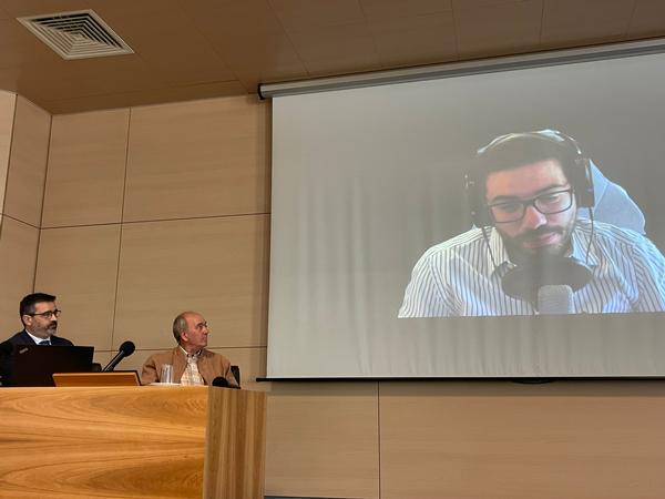 Panel moderator Jose Borges, Portugal Chapter vice president (l), and Jorge Reis Silva, faculty adviser, listen to  Bernardo Sequeiros, chapter president, during his video presentation during the September meeting. 
