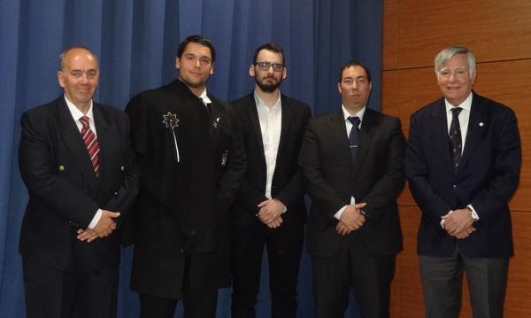 Adm. Rodolfo (r) presents the chapter's new board members at the May meeting. They include (l-r) Silva, faculty adviser; Alexandre Nunes, secretary; Joao Santos, second vice president; and Sanches, president.