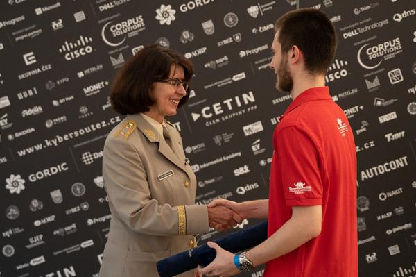 In May, Brig. Gen. Lenka Smerdova, Czech Armed Forces, advisor to chief of the General Staff, gives a special certificate of recognition to the overall winner, Peter Melnicek, Masaryk University.
