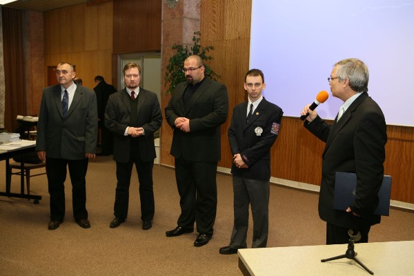 In November, Josef Požár (l), dean of faculty of security management, National Police Academy; Josef Strelec (r), chapter president; and Oldřich Krulk (2nd from l), student chapter president, present grants to Petr Pacher (c) and Alexandr Strach in recognition of their outstanding efforts in education.