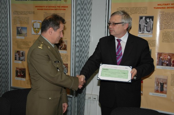 Czech Chapter President Josef Strelec presents an AFCEA Teaching Tool Grant to Lt. Col. Petr Hruza, student club president.