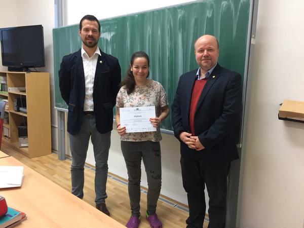 Miroslav Chytil, a cybersecurity officer at the Ministry of the Interior of the Czech Republic (l), honors top performer Michaela Oppitzova alongside Jirasek in November.