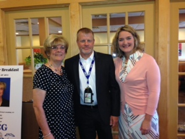 Claire Revalee, chapter Young AFCEAN vice president (r) greets Todd Vikan of TACG, The Ahrens Consulting Group, and Lynn Moad, former division chief of the Air Force Materiel Command's Systems Integration Division, during the chapter's Young AFCEAN Power Breakfast in July.