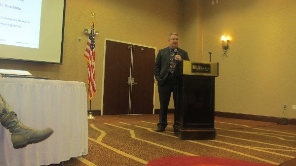 In August, Dr. Robert F. Mills, Air Force Institute of Technology (AFIT) professor of electrical engineering, speaks to the luncheon crowd.