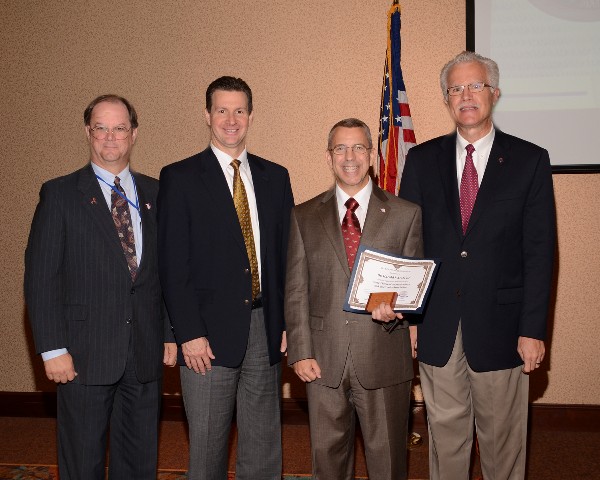 In July, Steve Duning (l) and Rick DaPrato (2nd from l) of SRC Incorporated present a $1,000 scholarship donation to Dr. Harold Arata (2nd from r) and Rick Wegmann, chairman of the chapter's board.