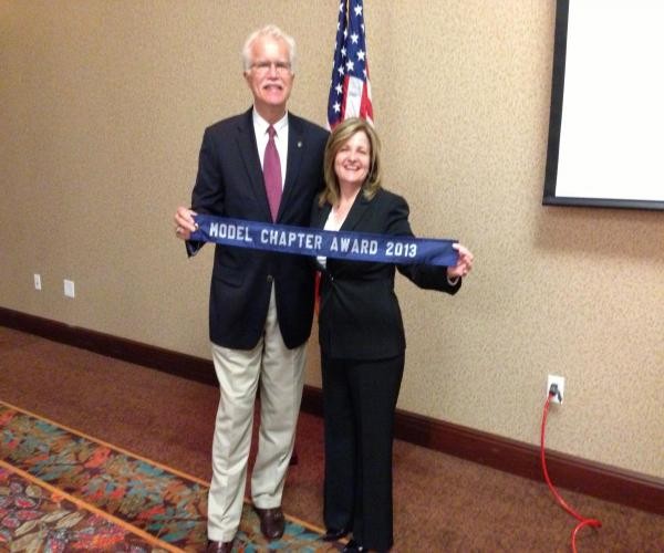 In May, Linda Skinner, chapter president, and Rick Wegmann, board chairman, present the chapter's Model Chapter Award.